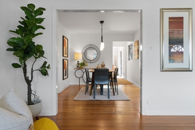 dining area featuring baseboards and wood finished floors