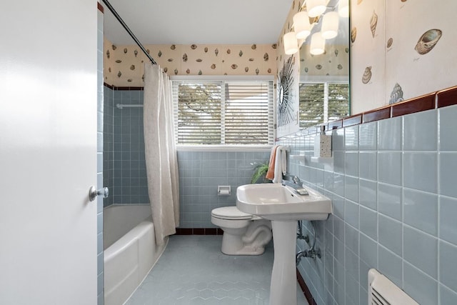 full bath with shower / bathtub combination with curtain, tile patterned floors, tile walls, toilet, and baseboard heating