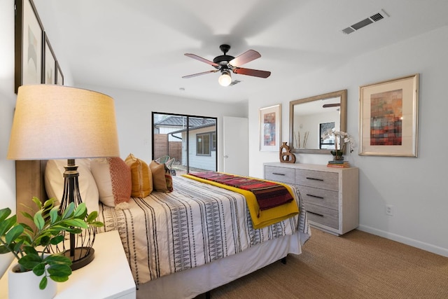 carpeted bedroom featuring a ceiling fan, access to exterior, baseboards, and visible vents