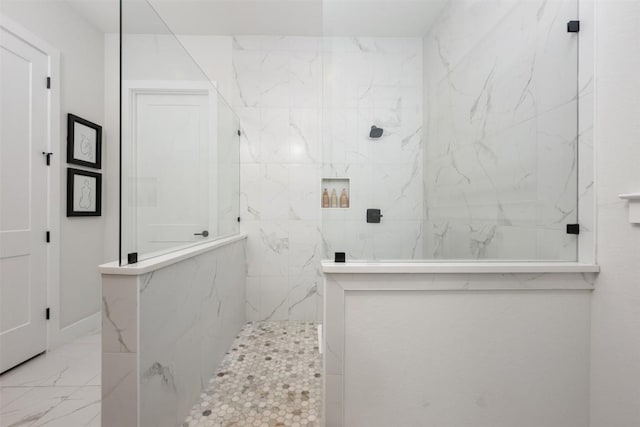 bathroom featuring a marble finish shower and marble finish floor