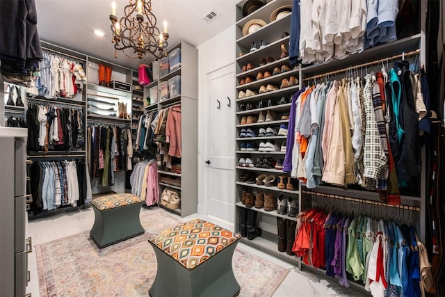 walk in closet with a notable chandelier and visible vents