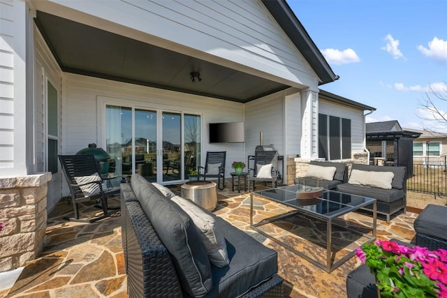 view of patio featuring outdoor lounge area and fence