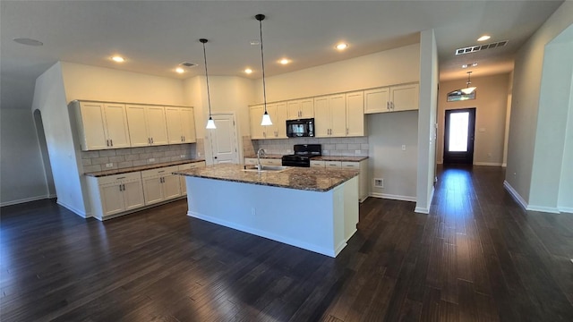 kitchen with visible vents, black appliances, dark wood finished floors, white cabinetry, and a sink