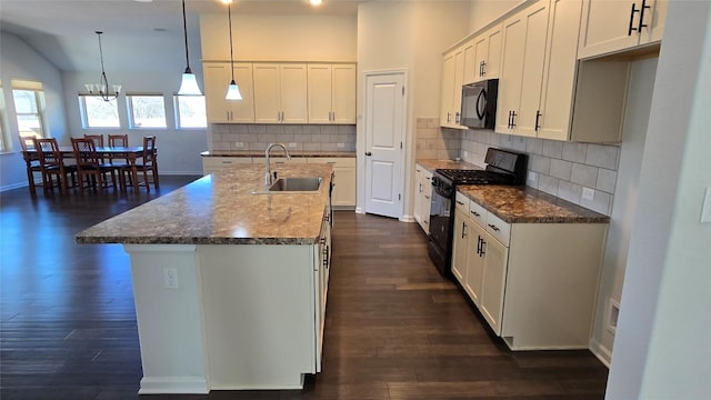 kitchen featuring a notable chandelier, black appliances, a sink, dark wood finished floors, and white cabinetry