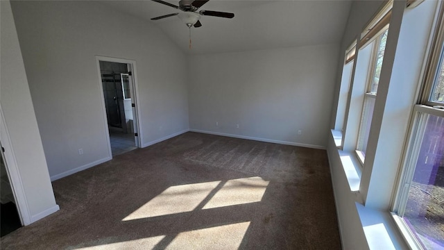 empty room with baseboards, lofted ceiling, ceiling fan, and carpet flooring