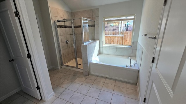 full bathroom with a bath, a stall shower, vaulted ceiling, and tile patterned flooring