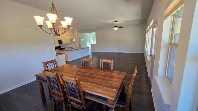 dining room with baseboards, dark wood finished floors, and ceiling fan with notable chandelier