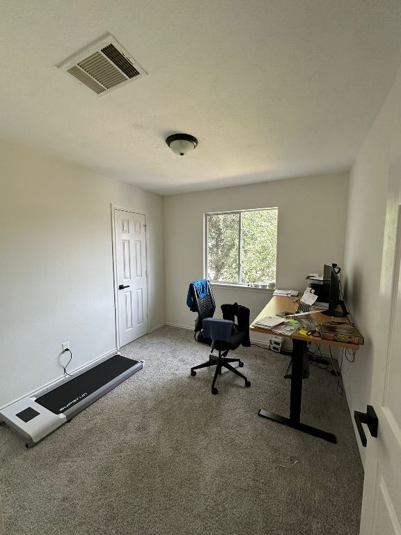 office area featuring visible vents and carpet floors