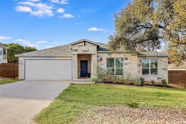 view of front of property with stone siding, an attached garage, driveway, and fence