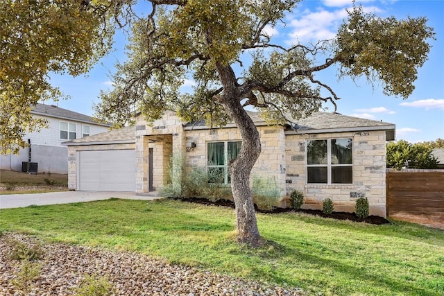 view of front facade featuring a front yard, central AC unit, stone siding, and driveway