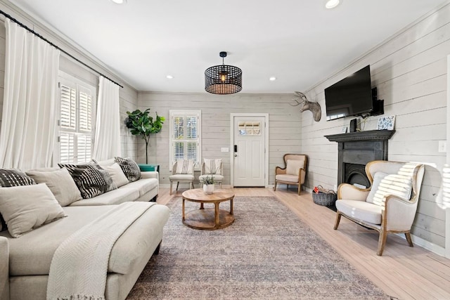 living room with a fireplace, recessed lighting, and light wood finished floors