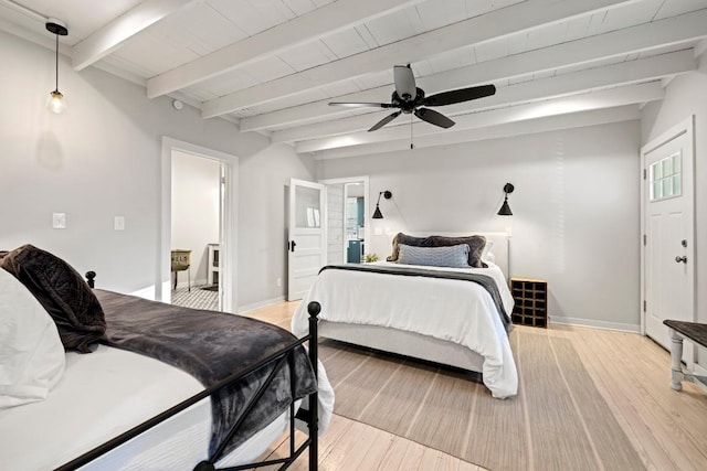 bedroom featuring baseboards, beam ceiling, and light wood-style flooring