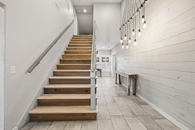 stairs featuring tile patterned floors and baseboards