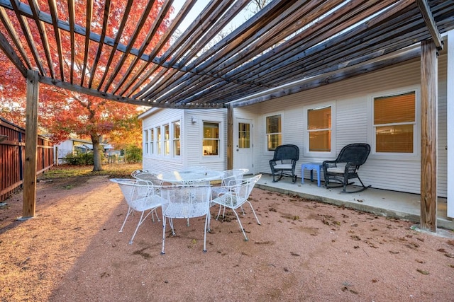 view of patio with outdoor dining area, a pergola, and fence