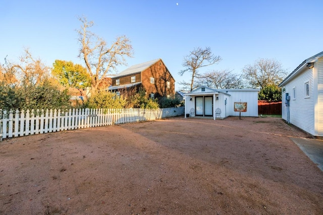 view of yard featuring an outdoor structure and fence