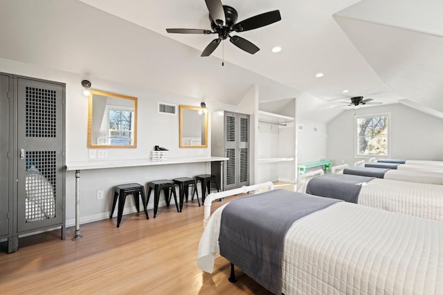 bedroom featuring visible vents, baseboards, lofted ceiling, recessed lighting, and light wood-style floors