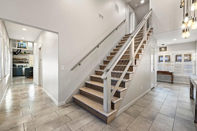 stairway with tile patterned flooring, recessed lighting, baseboards, and visible vents