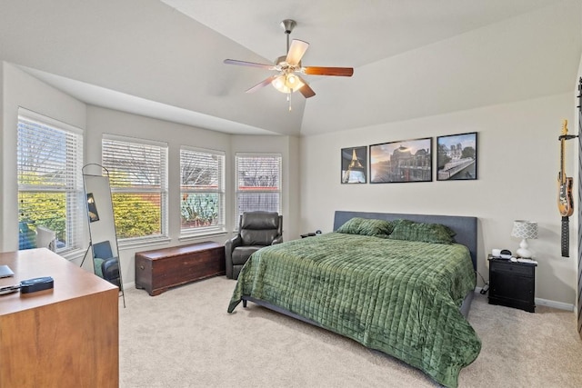 bedroom featuring multiple windows, lofted ceiling, baseboards, and carpet floors