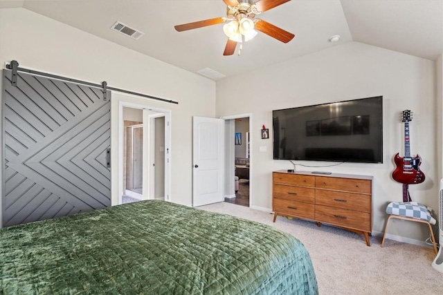 bedroom featuring visible vents, light colored carpet, a barn door, vaulted ceiling, and a ceiling fan