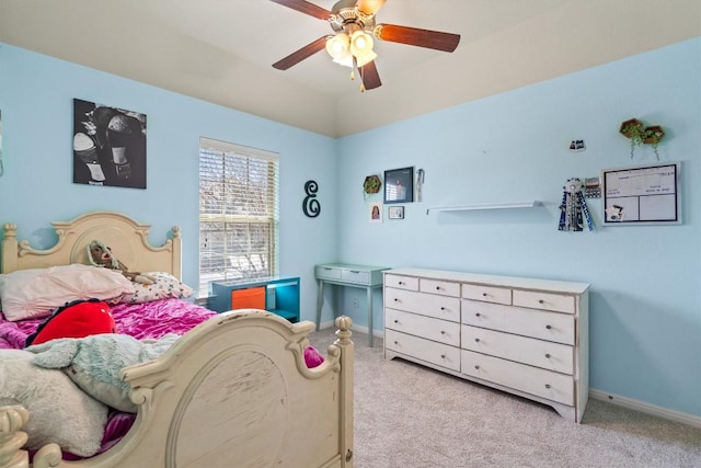 bedroom featuring baseboards, light colored carpet, and ceiling fan