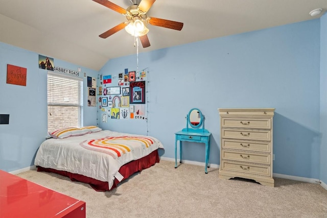 bedroom with baseboards, light colored carpet, and vaulted ceiling