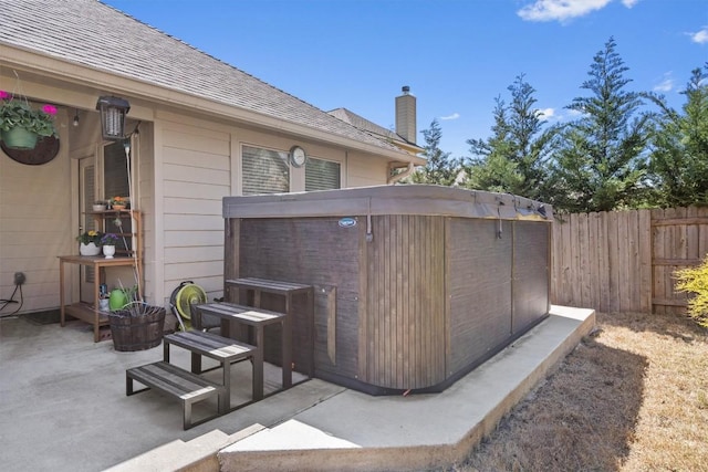 view of patio featuring a fenced backyard and a hot tub