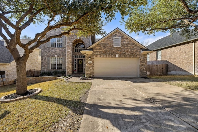 traditional-style house with concrete driveway, a garage, and brick siding