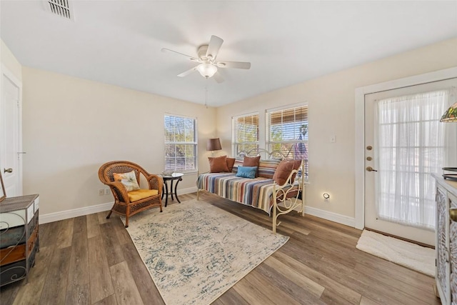 sitting room with visible vents, baseboards, ceiling fan, and wood finished floors