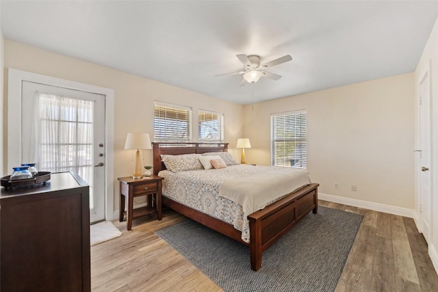 bedroom featuring baseboards, ceiling fan, and light wood finished floors