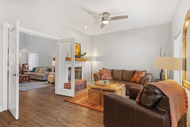 living area featuring a fireplace, wood finished floors, recessed lighting, and a ceiling fan