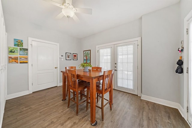 dining area with a ceiling fan, light wood-style flooring, french doors, and baseboards