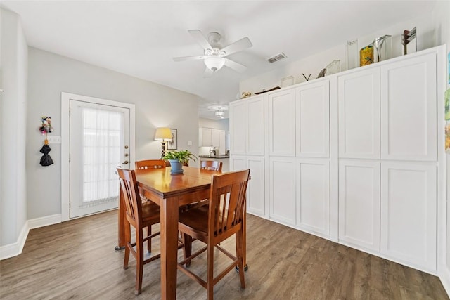 dining room featuring visible vents, baseboards, a ceiling fan, and light wood finished floors