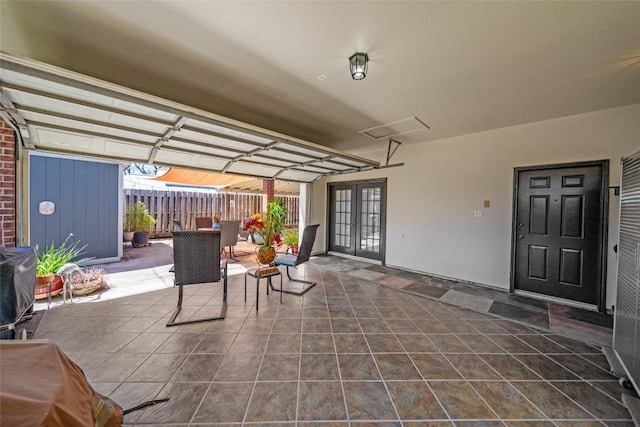 view of patio with french doors and fence