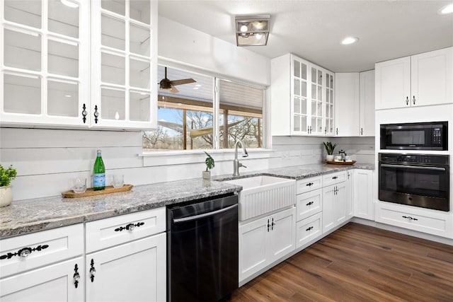 917 County Road 664, Devine, TX 78016 - kitchen with black oven, dishwashing machine, built in microwave, a sink, and white cabinets