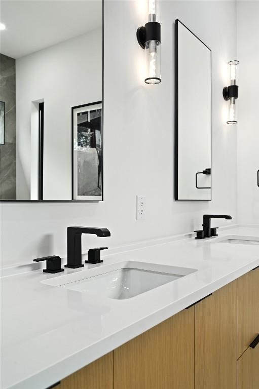 bathroom featuring a sink and double vanity