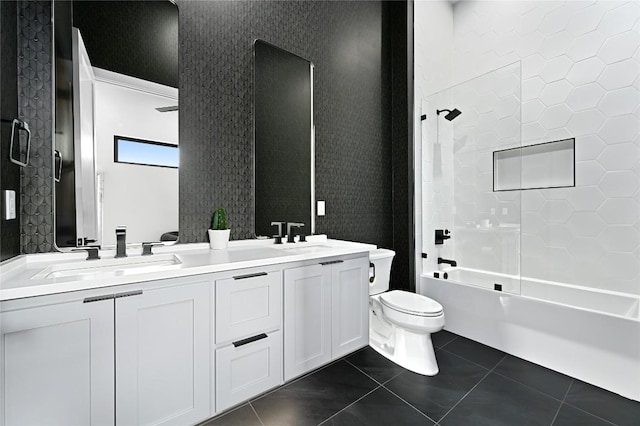 full bath featuring wallpapered walls, double vanity, a sink, tile patterned floors, and toilet