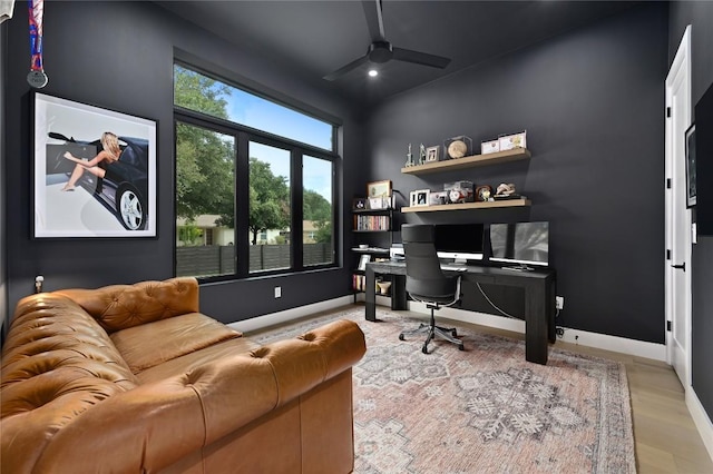 office area with baseboards, a ceiling fan, and wood finished floors