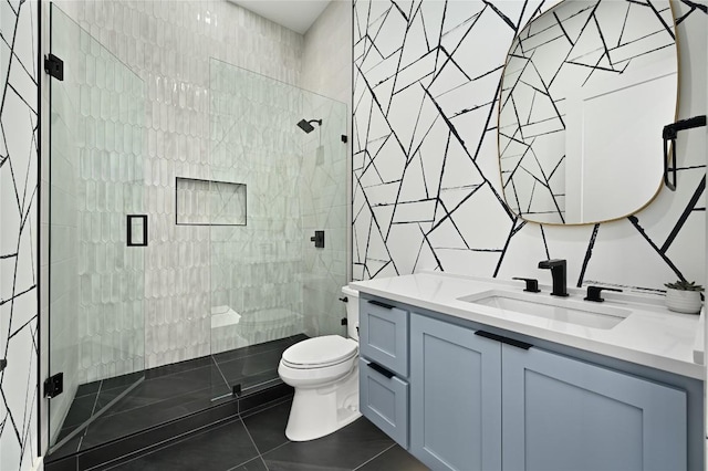 bathroom with toilet, tile walls, a shower stall, tile patterned flooring, and vanity