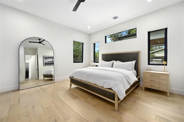 bedroom featuring a ceiling fan, baseboards, visible vents, and light wood-type flooring