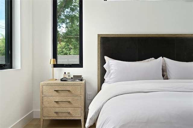 bedroom featuring baseboards and wood finished floors