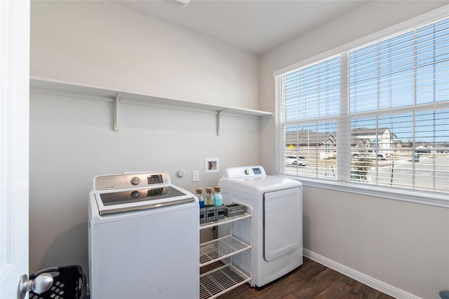 clothes washing area featuring baseboards, dark wood-type flooring, independent washer and dryer, and laundry area