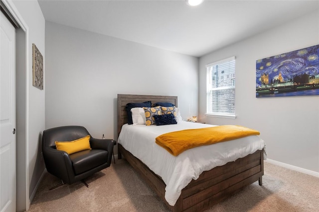 bedroom featuring baseboards and carpet