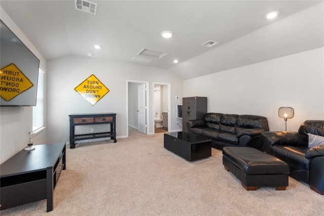 living area with visible vents, light colored carpet, and lofted ceiling