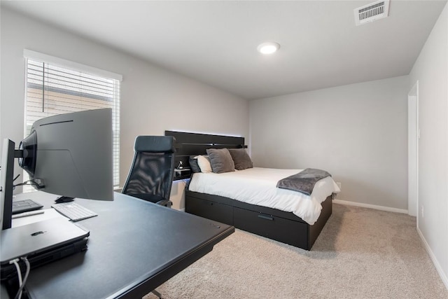 bedroom featuring baseboards, visible vents, and light carpet