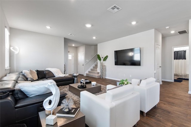 living room featuring dark wood finished floors, recessed lighting, and visible vents