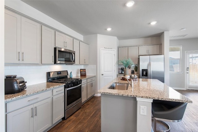 kitchen featuring a sink, gray cabinetry, tasteful backsplash, and stainless steel appliances