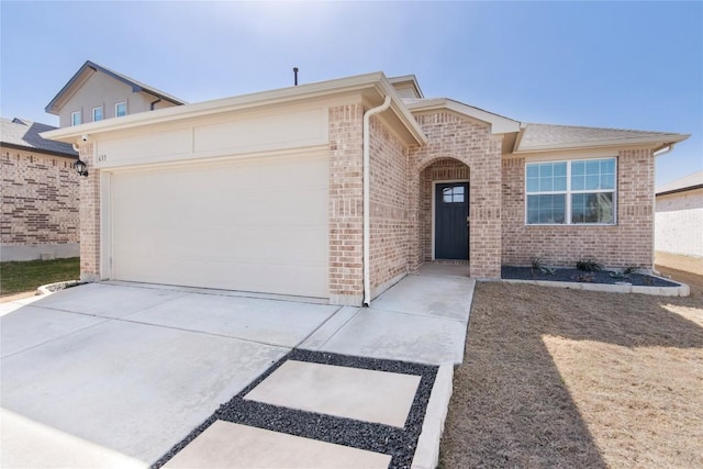 ranch-style home featuring brick siding, concrete driveway, and a garage