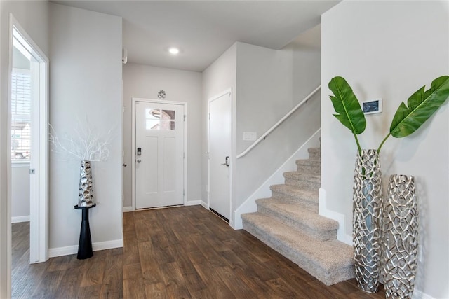 entryway with dark wood finished floors, recessed lighting, stairs, and baseboards