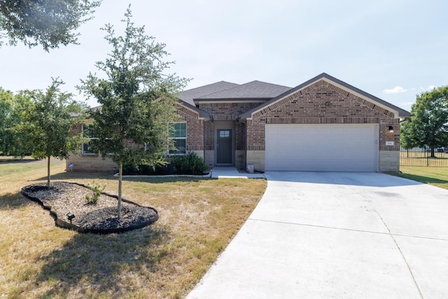 ranch-style home with a front yard, fence, driveway, an attached garage, and brick siding