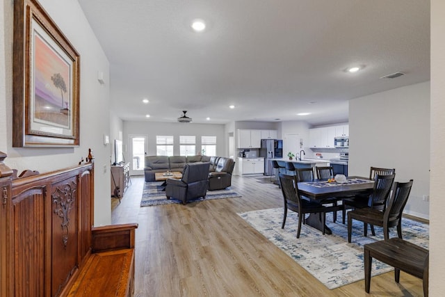 dining room with light wood finished floors, visible vents, baseboards, ceiling fan, and recessed lighting